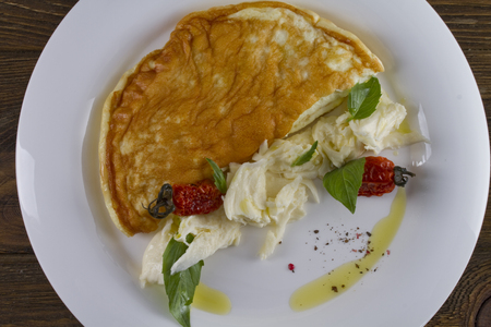 A light breakfast - an omelette with dried tomatoes and rye breadの写真素材