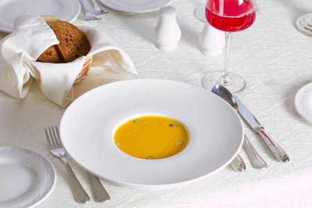 Pumpkin soup with seeds and rye breadの写真素材