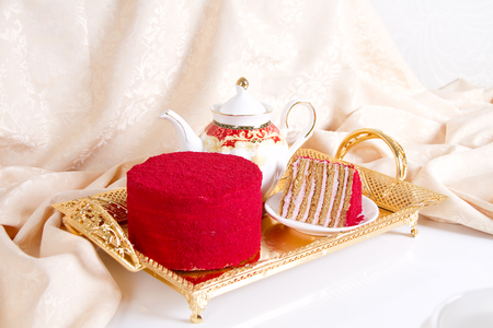 Fruit honey cake and teapot with green teaの写真素材