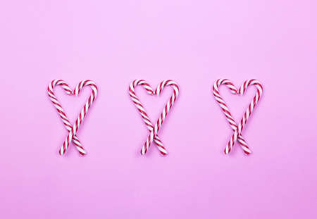 heart lollipops on a pink background