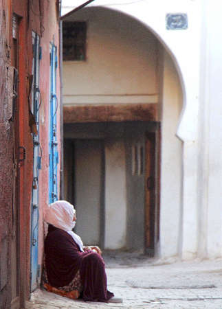 Marrakech, Morocco, July 27, 2019. A woman, prays on a street in the medina.のeditorial素材