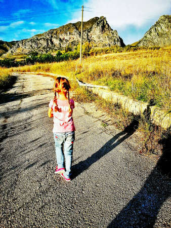 Little girl walking aloneの素材