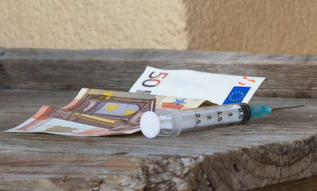 Fifty euro with syringe, drug conceptの写真素材