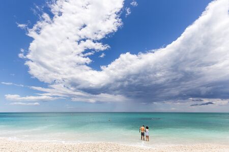 Young couple bathing on the sea with a stormy weatherのeditorial素材