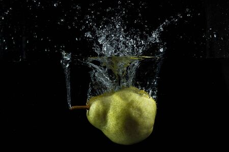 pear falling into the waterの写真素材
