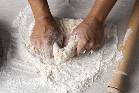 hands kneading flour