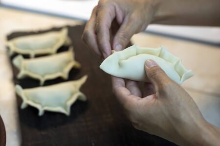 hands making repulgue of empanadasの写真素材