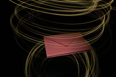 Red envelope decorated in light painting on a black backgroundの写真素材