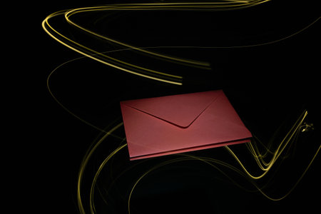 Red envelope decorated in light painting on a black backgroundの写真素材