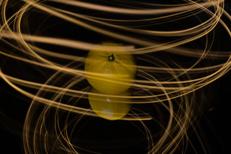 Orange fruit in the center with lightpainting effectの写真素材