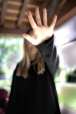 woman covers her face to protect herself from violenceの写真素材