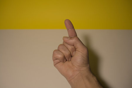 isolated point finger white and yellow background copy space leftの写真素材