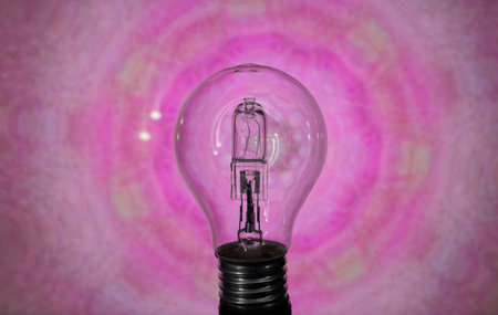 Incandescent light bulb on a pink background, close-upの写真素材