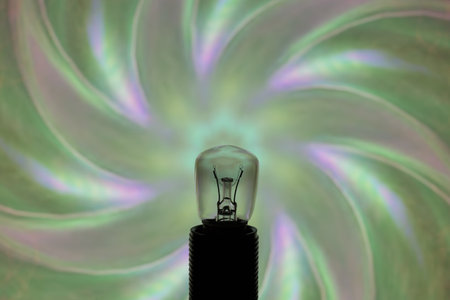 Light bulb on a green background with a spiral in the center.の写真素材