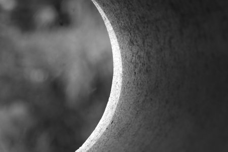 Black and white abstract background of curved concrete pipe. Closeups.の写真素材