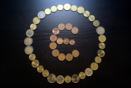 Coins in the form of the letter E on a dark background