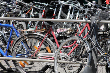 Bicycles parked in a row in a parking lot on a sunny dayの写真素材