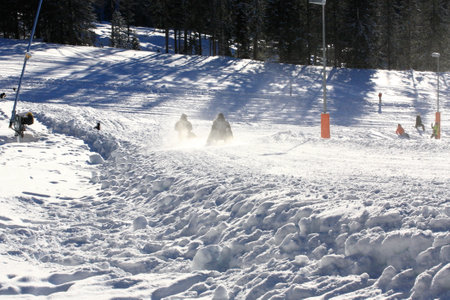 Skiing in the mountains on a sunny day in winter.の写真素材