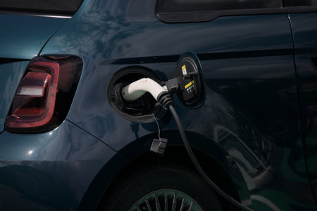 Charging an electric car with the power supply plugged into it.の写真素材