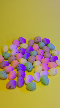 Colorful easter eggs on yellow background. Happy easter.の写真素材