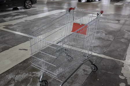 Empty shopping cart on the floor in the parking lot, stock photoの写真素材
