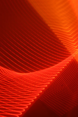 abstract red background with motion blurred waves, lines and bokehの写真素材