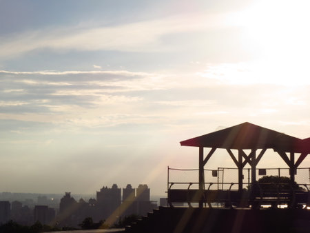 Sunset over the city, silhouette of a gazeboの写真素材