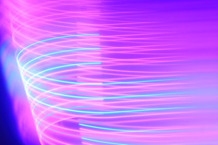 abstract background with blue and purple lines and waves on a dark backgroundの写真素材