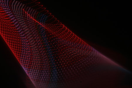 abstract background with glowing particles in red, blue and black colors