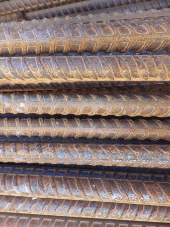 Close up of a pile of rusty steel bars in a construction siteの写真素材