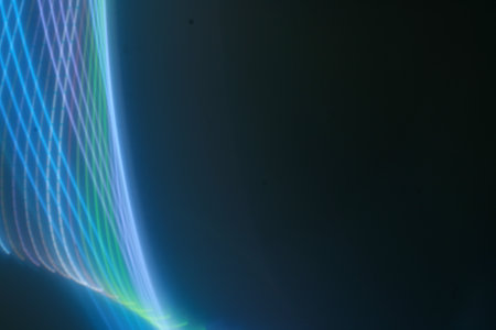 abstract background with blue and green lines on a black background.