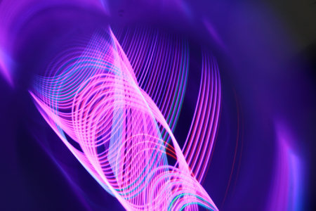 abstract background of the colorful blurred lights on a dark background.
