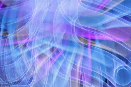 Abstract blue and purple smoke on a black background. Close-up.