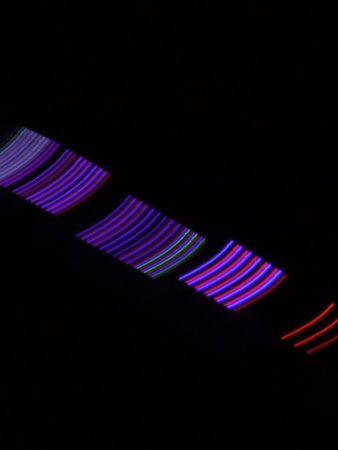 abstract colored lines on a black background close-up of lightの写真素材