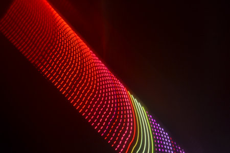 abstract background of colored lines and bokeh in the darkの写真素材