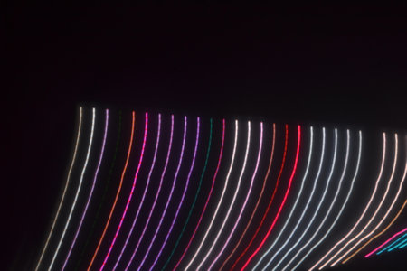 Colorful light trails on a black background. Long exposure photograph.の写真素材