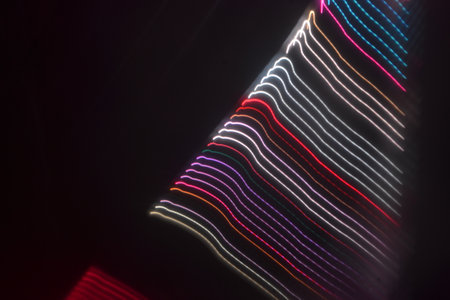 abstract background of the strips of colored light in the dark.