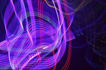 Abstract light painting on a black background. Long exposure photo with motion blur.