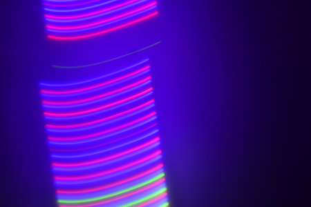 Abstract background of blue and purple neon strips on a black background.の写真素材