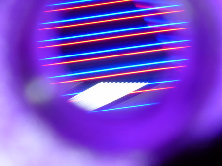 abstract background of the colored neon lights on a black background.