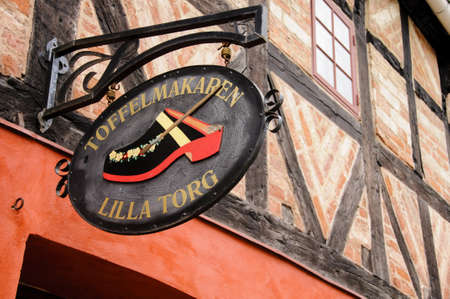Malmo, Sweden - August 2010: Wooden shop sign on an historic building in Lilla Torget in Malmo,...