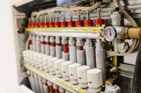 Insulated pipes and valves in a centralized heating and air conditioning systemの写真素材