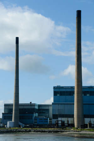 A production plant with two big chimneys close to the waterのeditorial素材