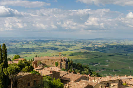 Rooftops of Montalcino and scenic view of typical Tuscany landscape in Val D'Orcia: hills, meadows and green fields. Tuscany, Italy, Europeの写真素材