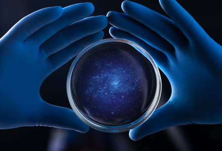 Doctor hand holds petri dish with galaxyの写真素材