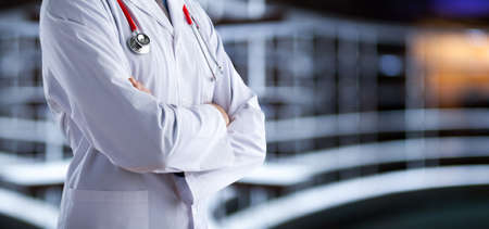 Doctor with medical stethoscope on hospital backgroundの写真素材
