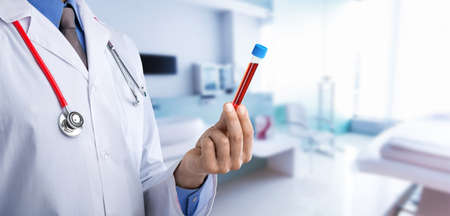 Doctor with medical tube on hospital backgroundの写真素材
