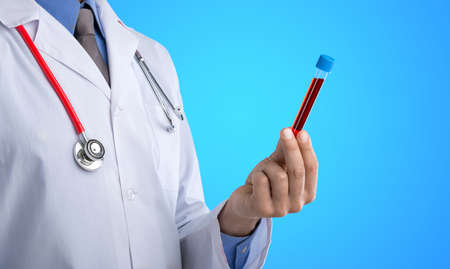 Doctor with medical tube on hospital backgroundの写真素材