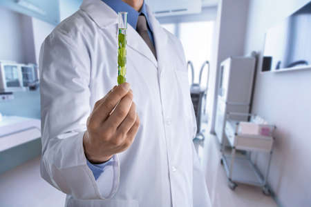 Doctor with medical tube on hospital backgroundの写真素材