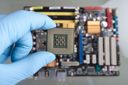 The scientist holds the computer part